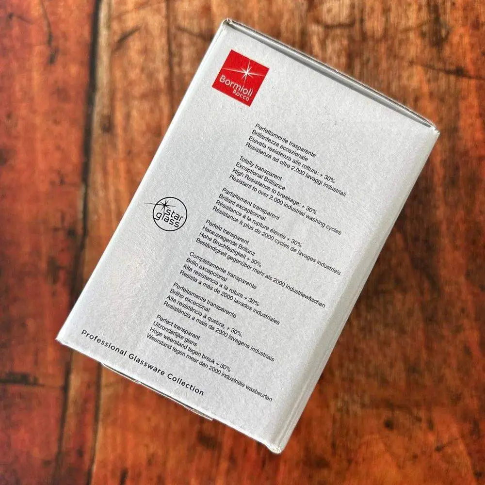 Product packaging with text and a logo on a wooden surface