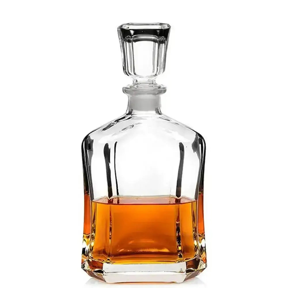 Clear glass whiskey decanter with a white background