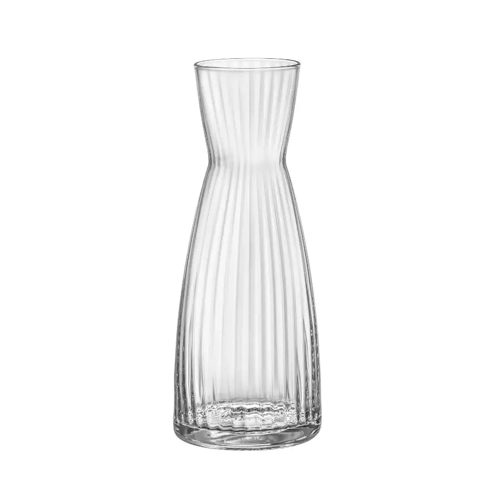 Clear glass carafe with ribbed design on a white background