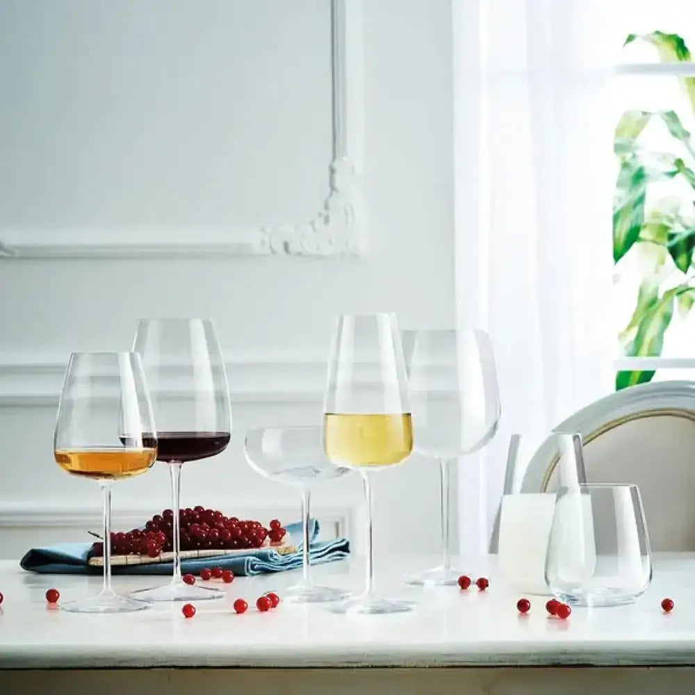 Set of wine glasses with different types of wine on a kitchen counter.
