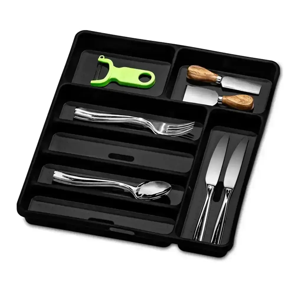 Black cutlery organizer with silverware and a green bottle opener on a white background