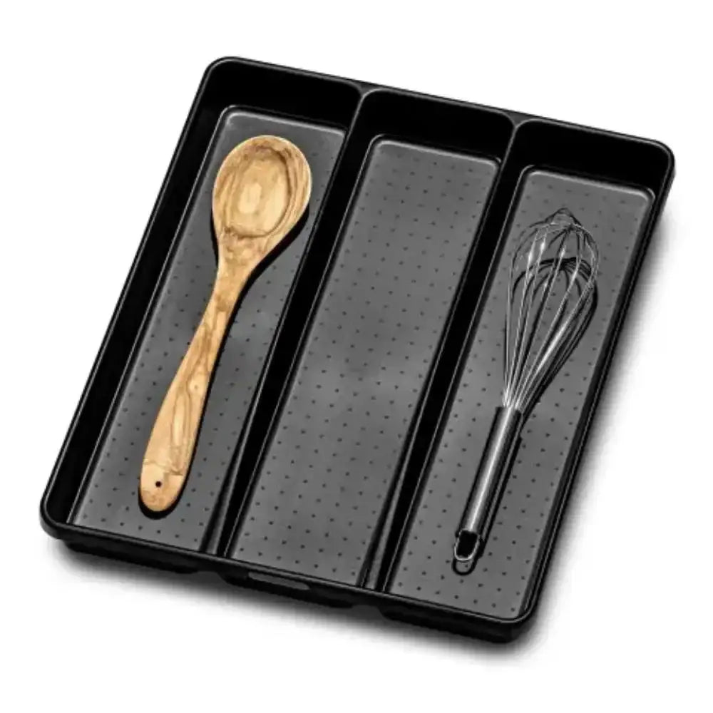 Black utensil holder with wooden spoon and metal whisk on a white background
