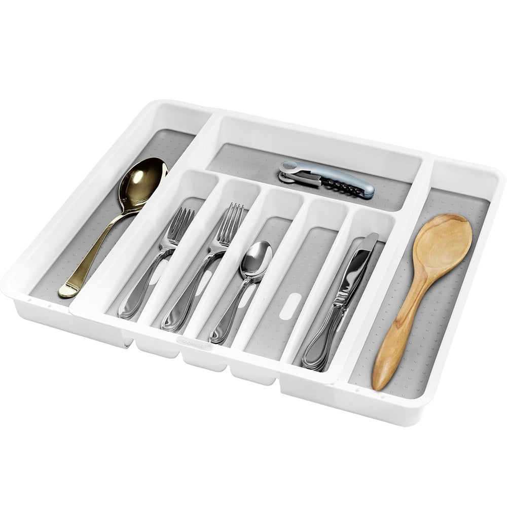 White cutlery organizer with silverware and a wooden spoon on a white background