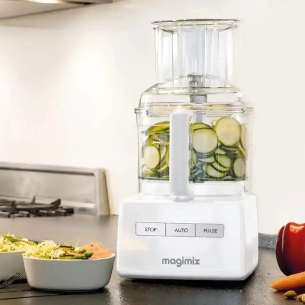 Magimix food processor with sliced vegetables on a kitchen counter