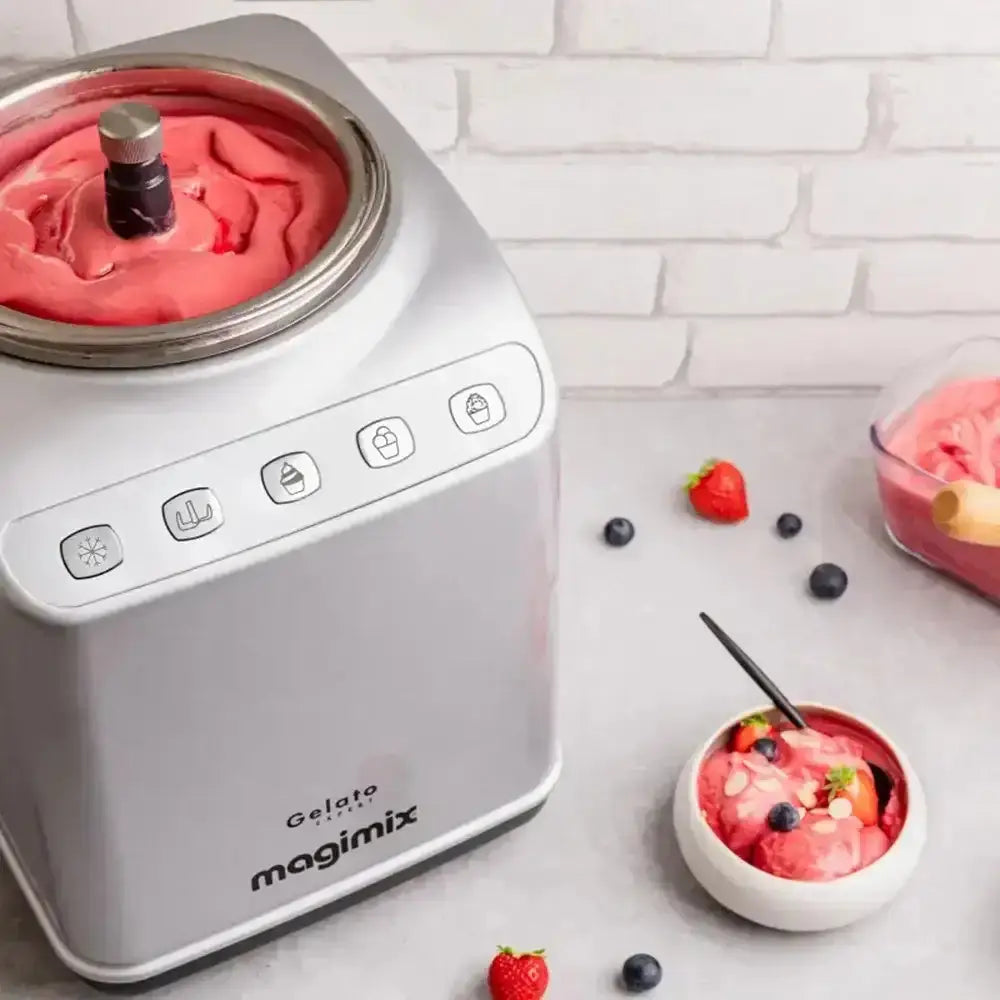 Magimix gelato maker with pink ice cream and a bowl of ice cream on a light background