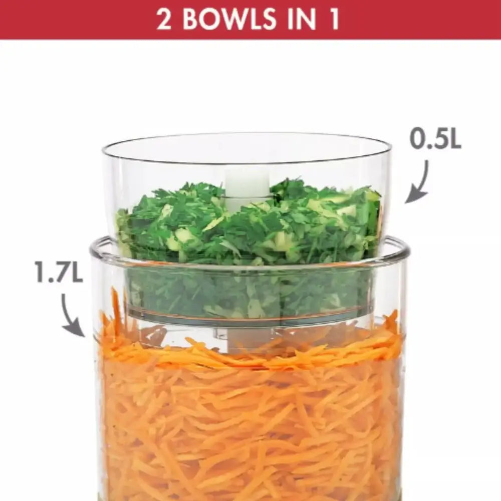 Two-tiered food processor with greens on top and carrots on bottom, labeled for volume.