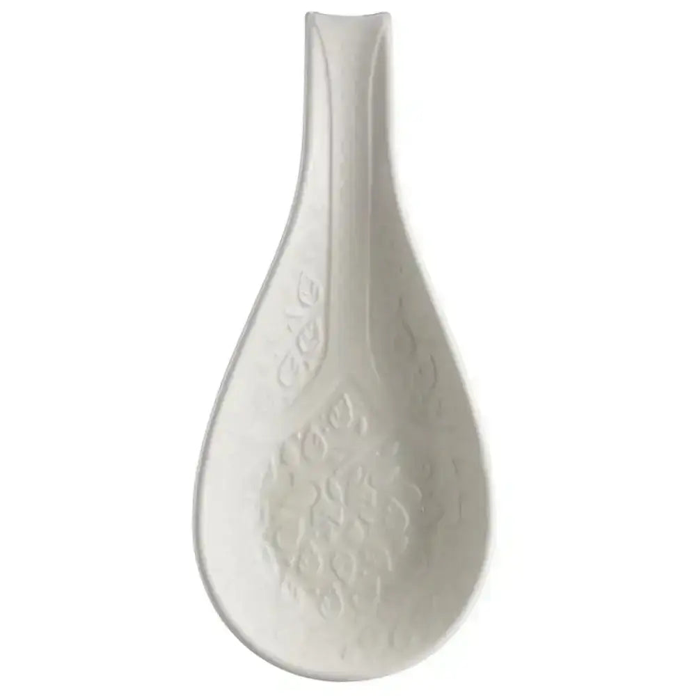 White ceramic spoon rest with teardrop shape and embossed floral patterns from mason cash in the forest collection