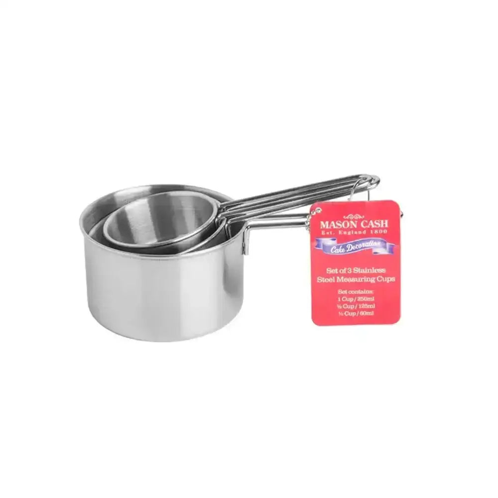 Set of three stainless steel mason cash measuring cups with sleek reflective surfaces and integrated handles