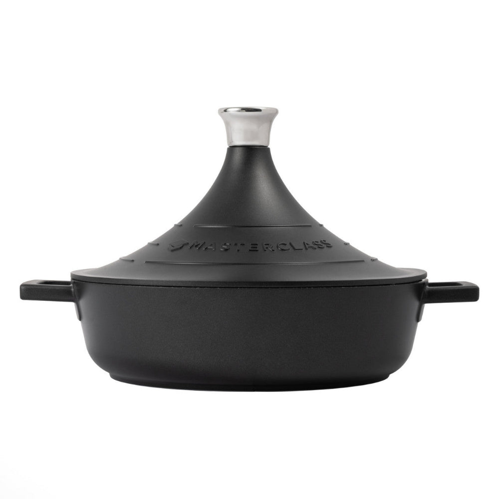 Black tagine pot with silver lid on a white background