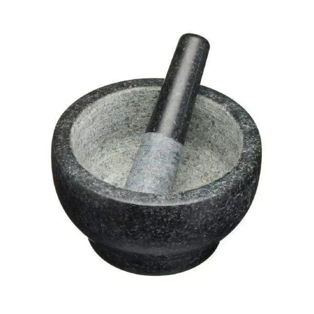 Mortar and pestle made of dark stone on a white background