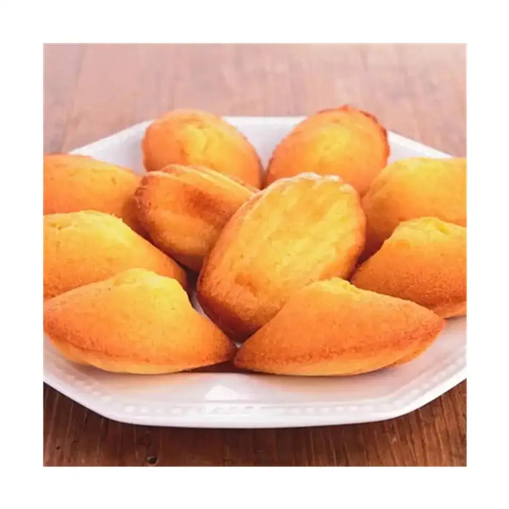 Plate of golden-brown pastries on a wooden surface