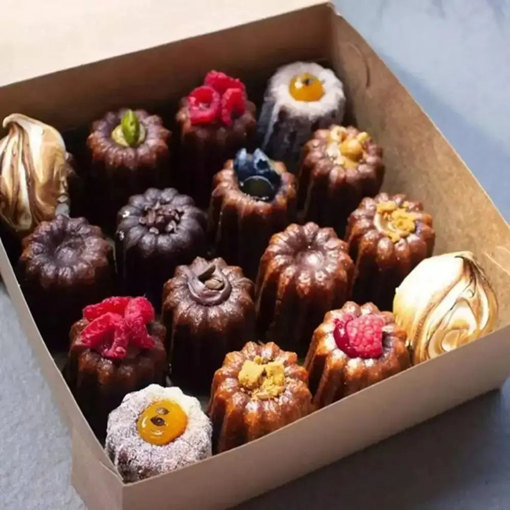 Assorted small desserts in a box on a light background