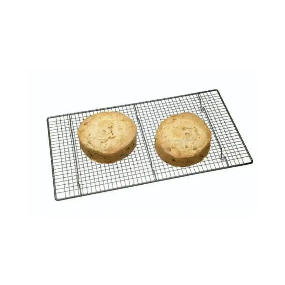 Two round cakes on a cooling rack with a white background