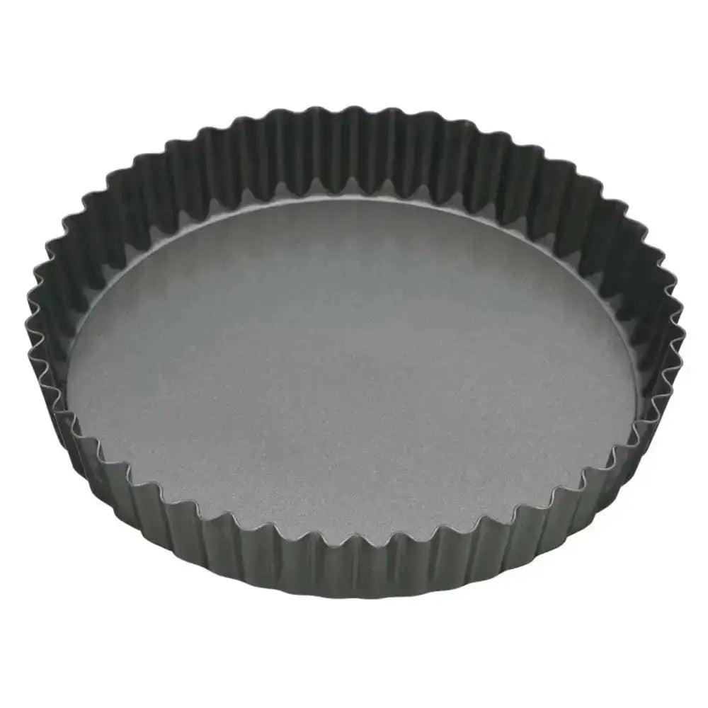Black fluted tart pan on a white background