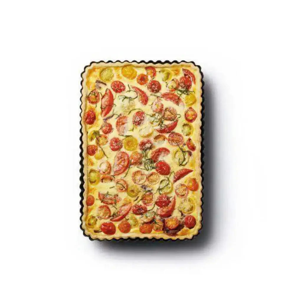 Rectangular tart with tomato pattern on a white background