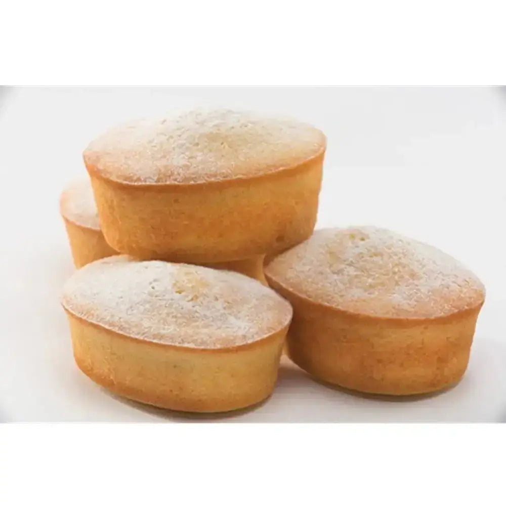 Four small round cakes dusted with powdered sugar on a white background