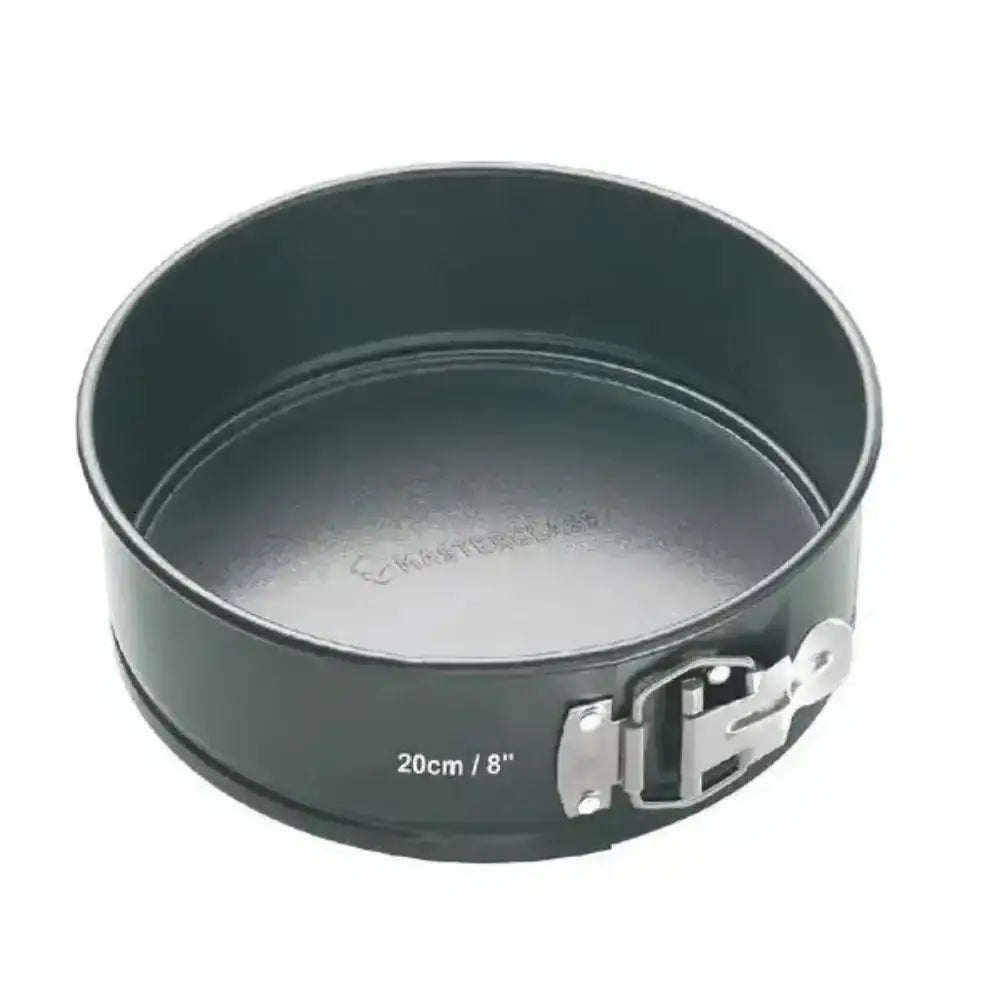 Round metal baking pan with springform base on a white background