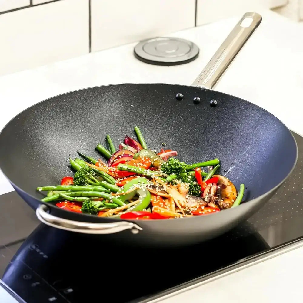 Wok with stir-fried vegetables on a stovetop