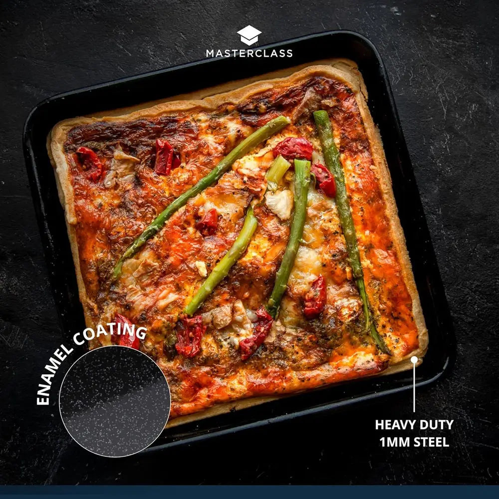 Square pizza with vegetables on a black baking tray, featuring 'Masterclass' branding and text about enamel coating and heavy-duty steel.