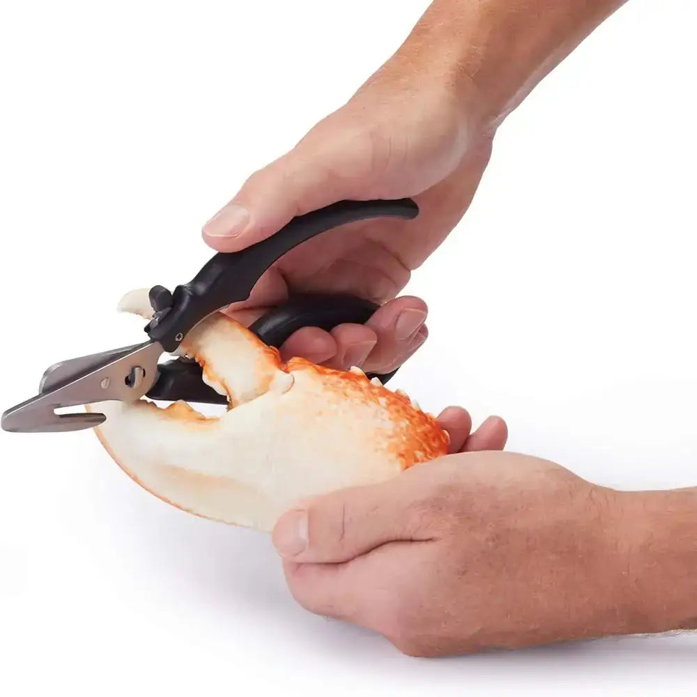 Person using a crab leg shredder tool on a white background