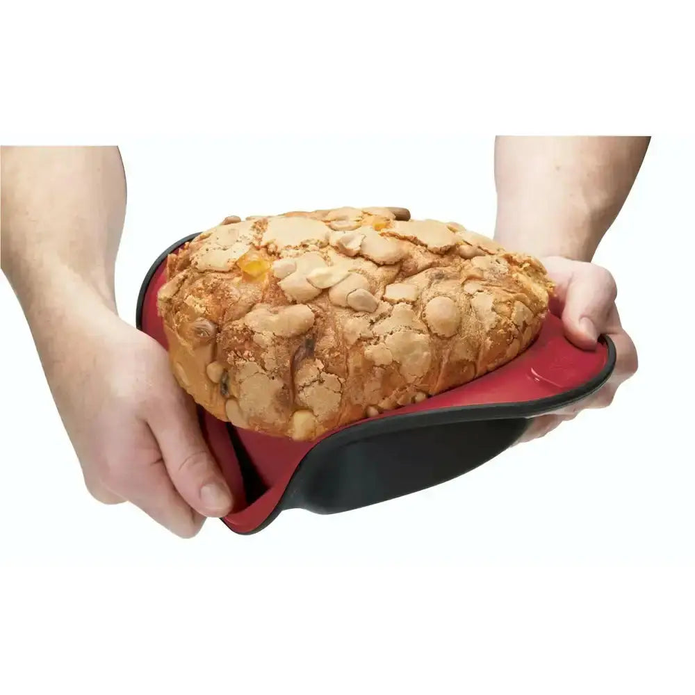 Person holding a loaf of bread in a red and black container on a white background