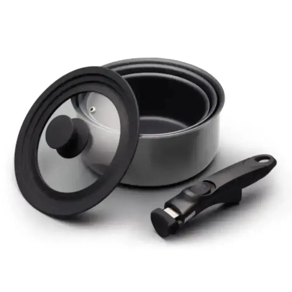 Set of cookware including a pot, lid, and handle on a white background