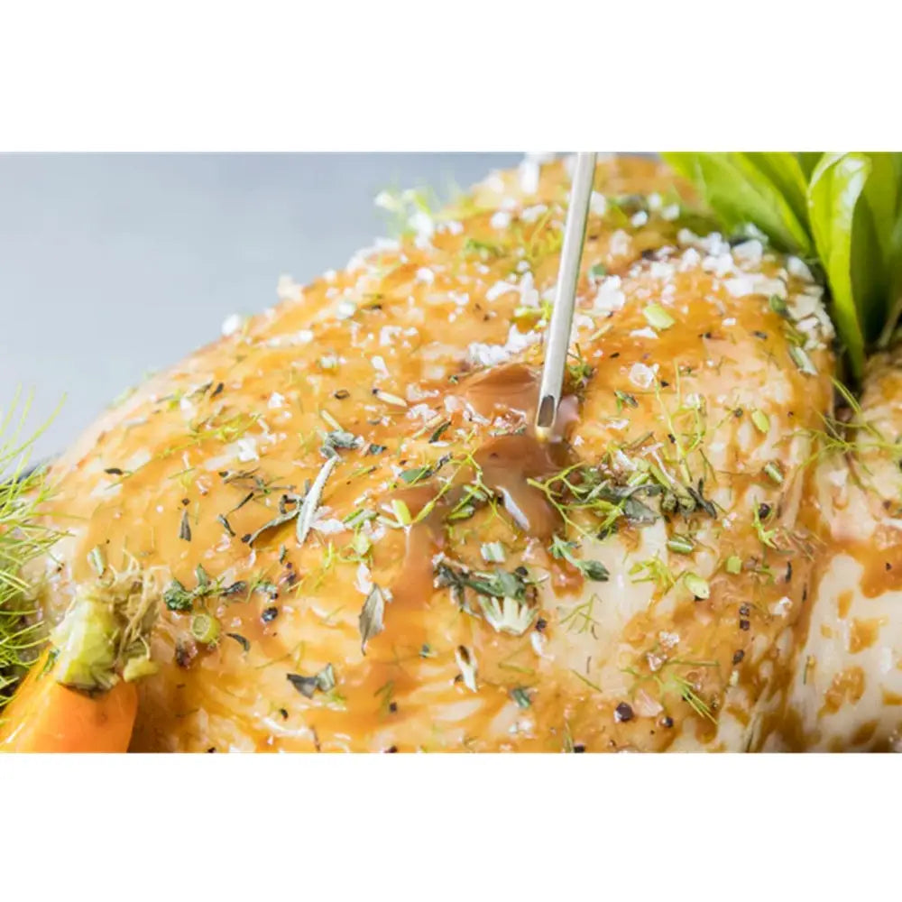 Roasted chicken with herbs on a white plate