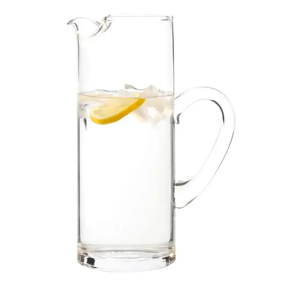 Clear glass pitcher with lemon slice and ice cubes on a white background