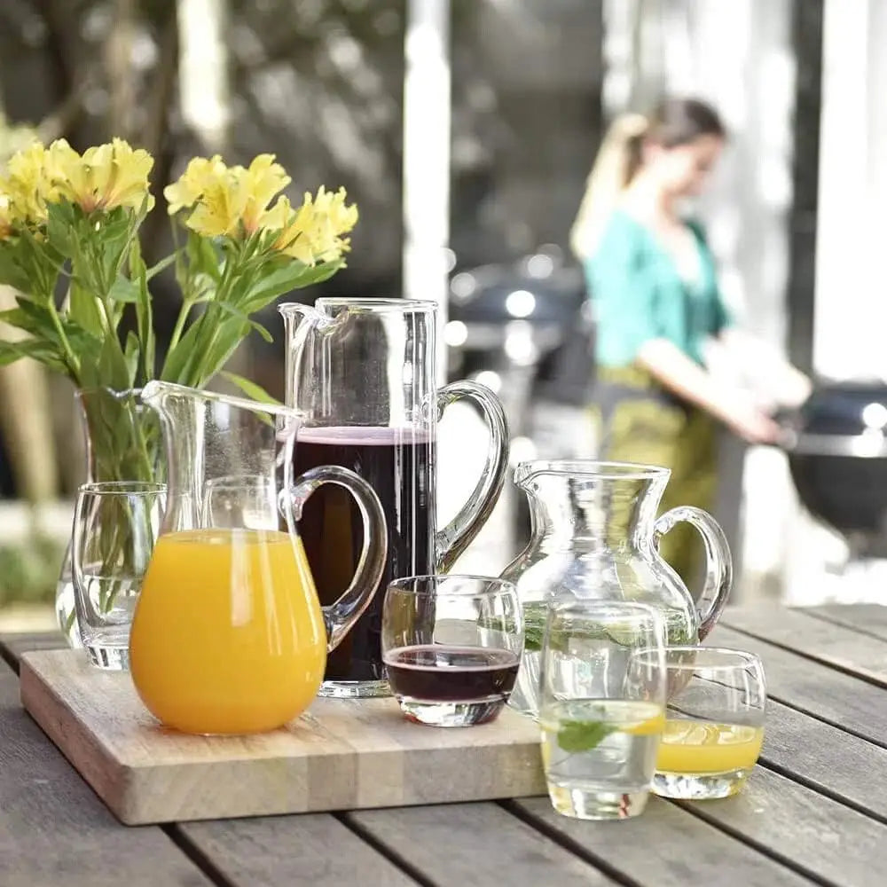 Outdoor setting with drinks and flowers on a wooden table