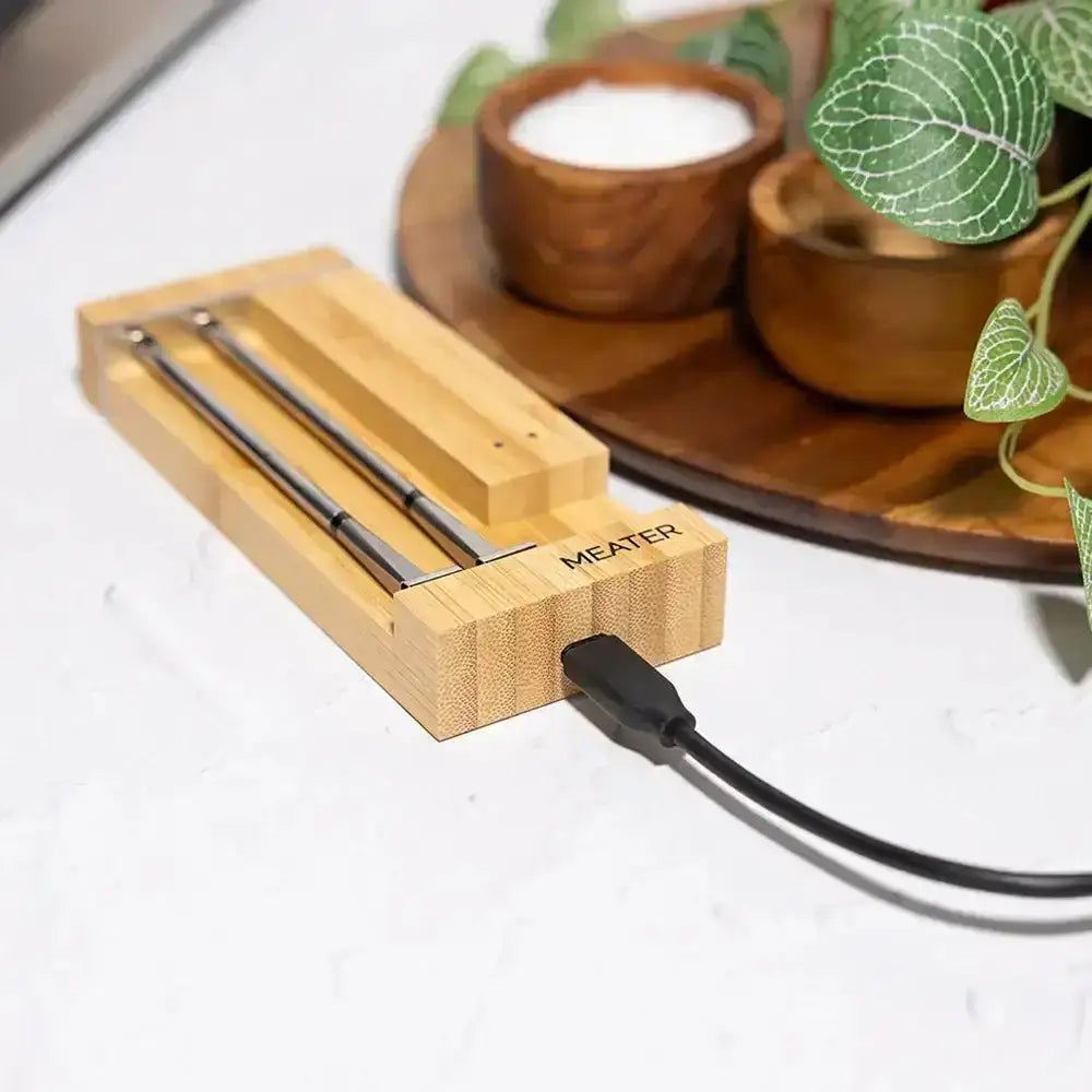 Wooden meat thermometer with a cable on a white surface