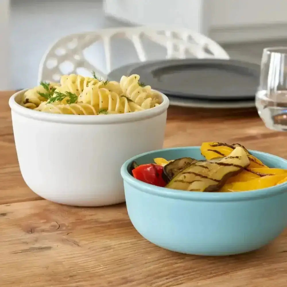 White ceramic mepal cirqula deep bowl filled with spiral pasta and fresh dill in nordic white set of 3