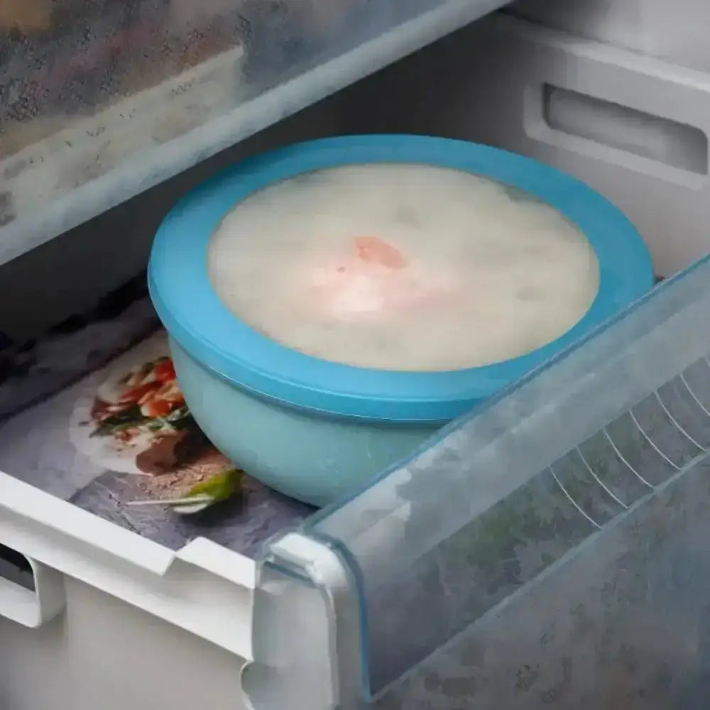 Mepal Cirqula deep light blue plastic bowl with matching lid containing frozen food from Nordic white set of 3