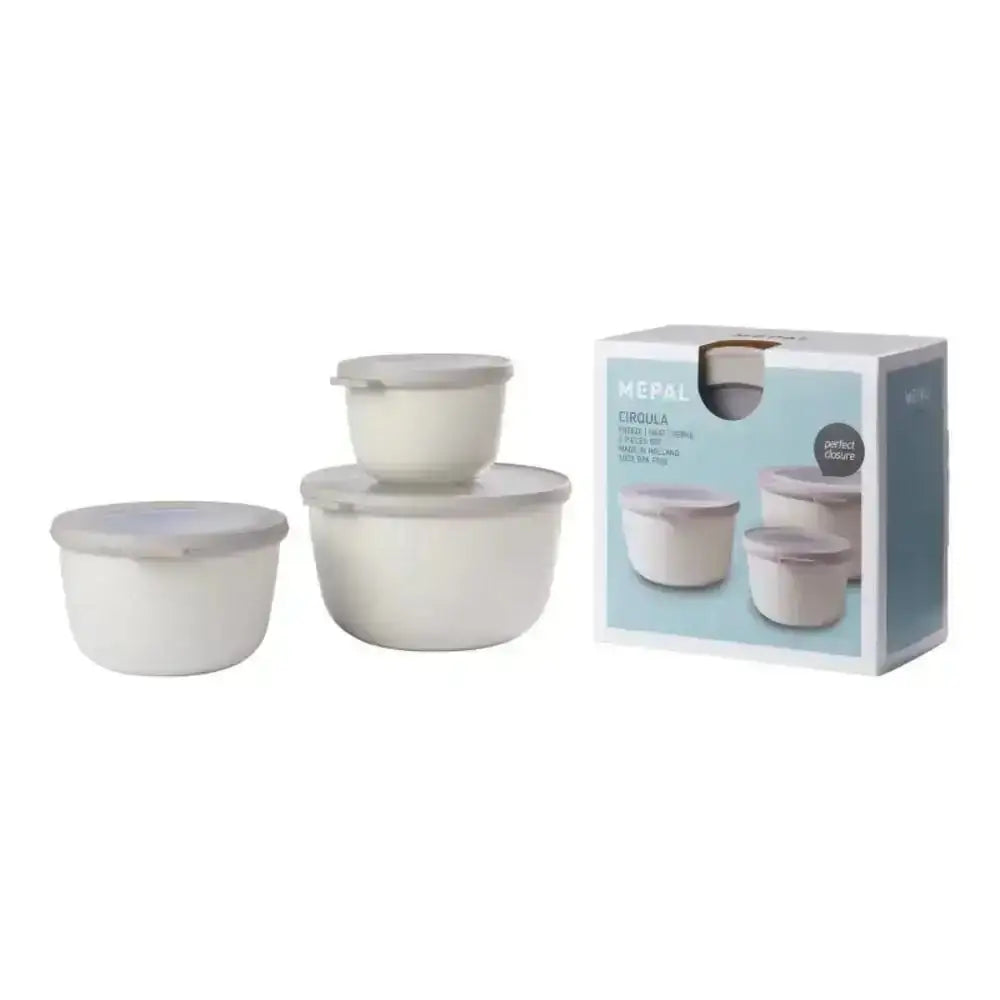 Set of three white ceramic Mepal Cirqula deep bowls with matching lids neatly arranged beside branded packaging