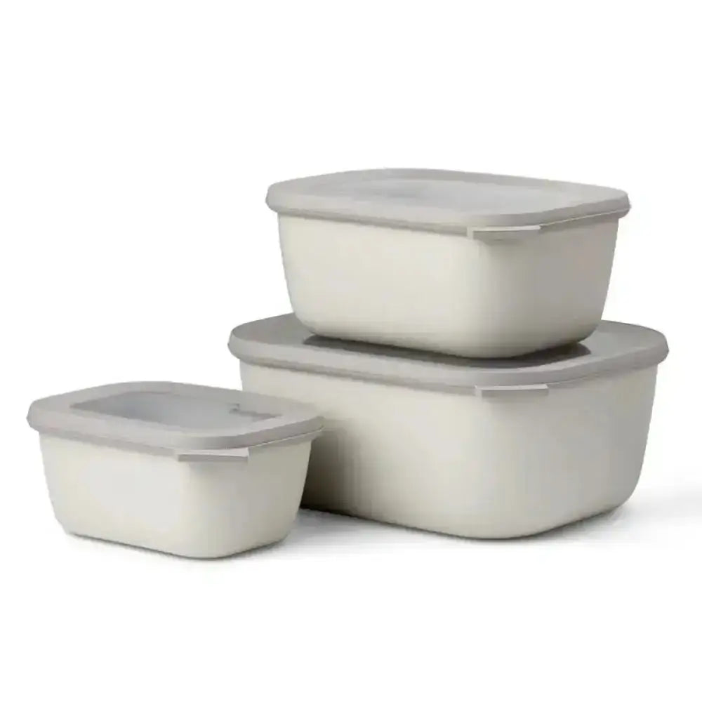 Set of three beige food storage containers with lids on a white background