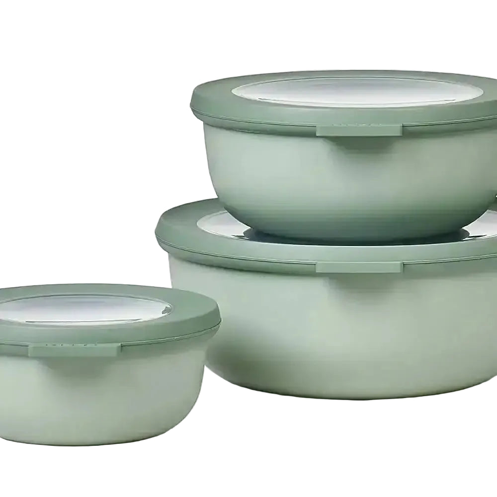 Set of three green bowls with lids on a white background