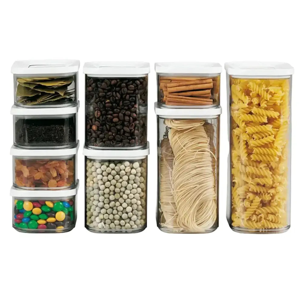 Set of clear storage containers with various food items on a white background