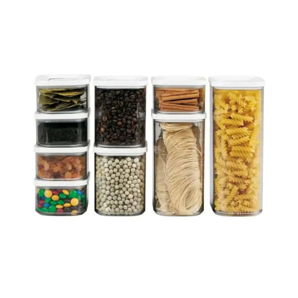 Set of clear storage containers with various food items on a white background
