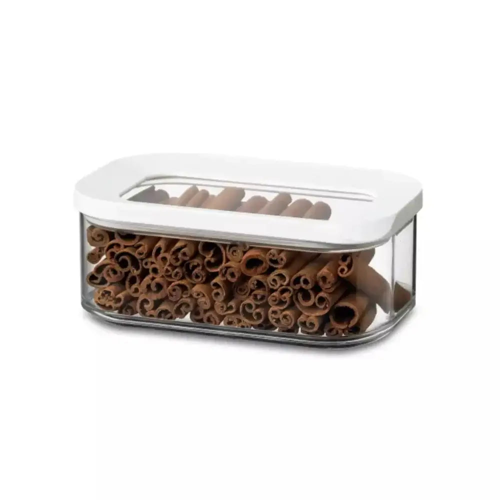 Container with cinnamon sticks on a white background