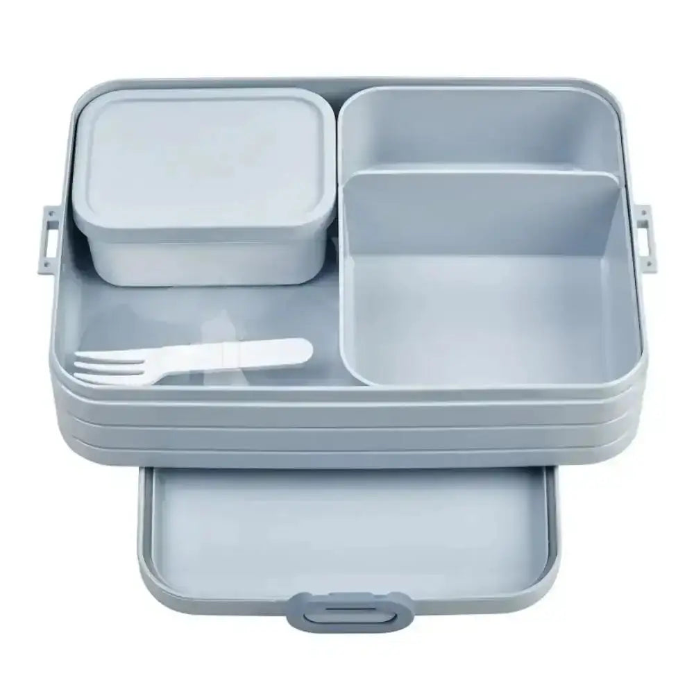 Blue bento-style lunch box with compartments, small container, and white fork