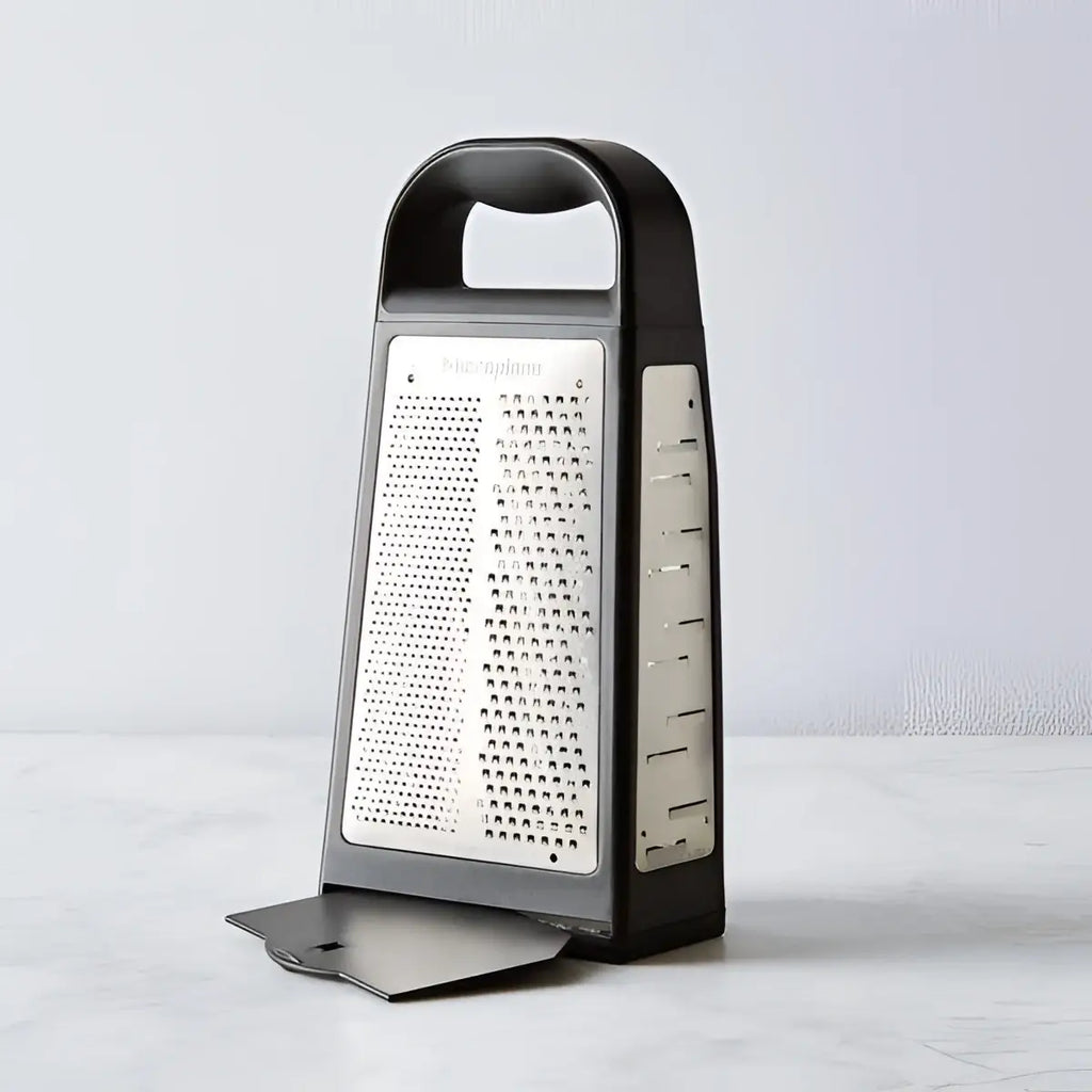 Box grater with black handle and body on a light gray background