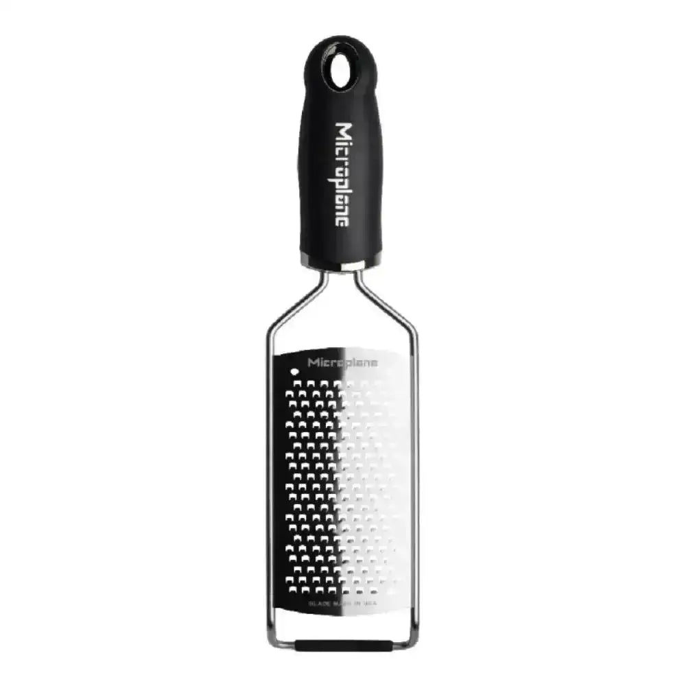 Rectangular cheese grater with black handle on a white background