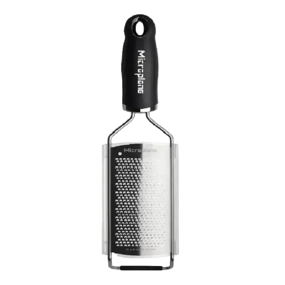 Microplane grater with black handle on a white background