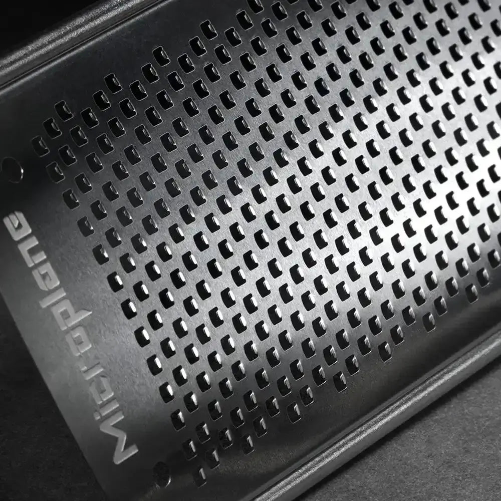 Metallic grille on a dark background