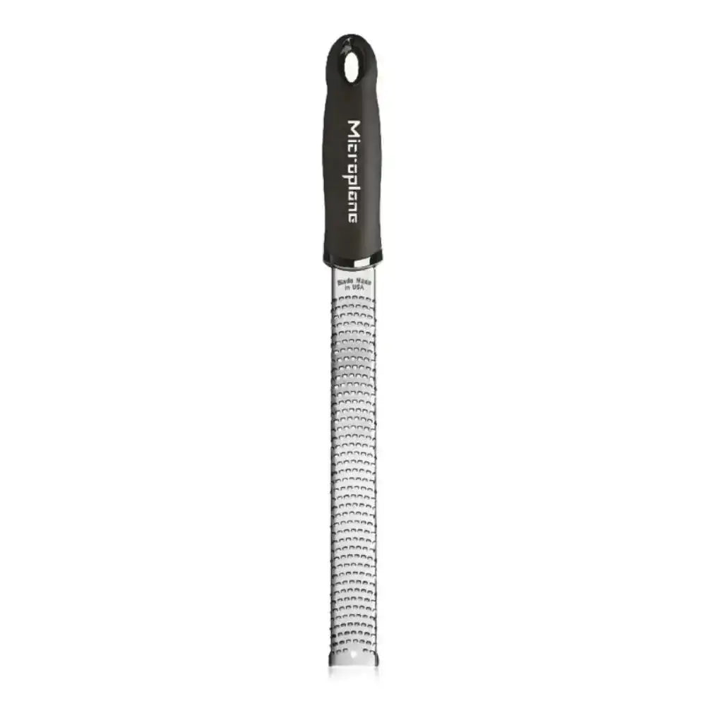Microplane zester with black handle on a white background