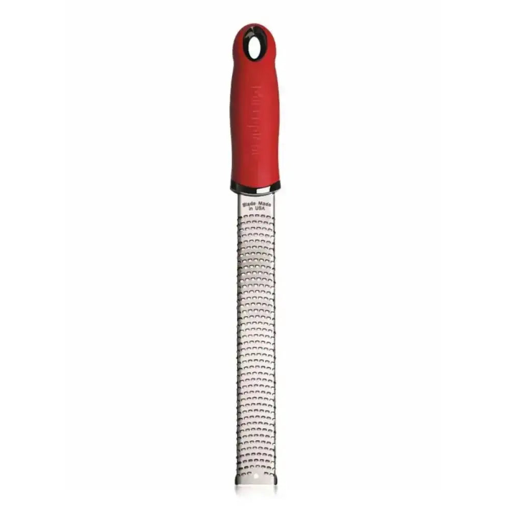 Red-handled zester on a white background