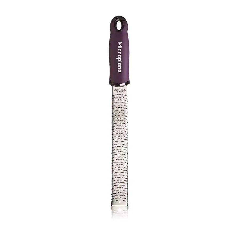 Microplane grater with purple handle on a white background