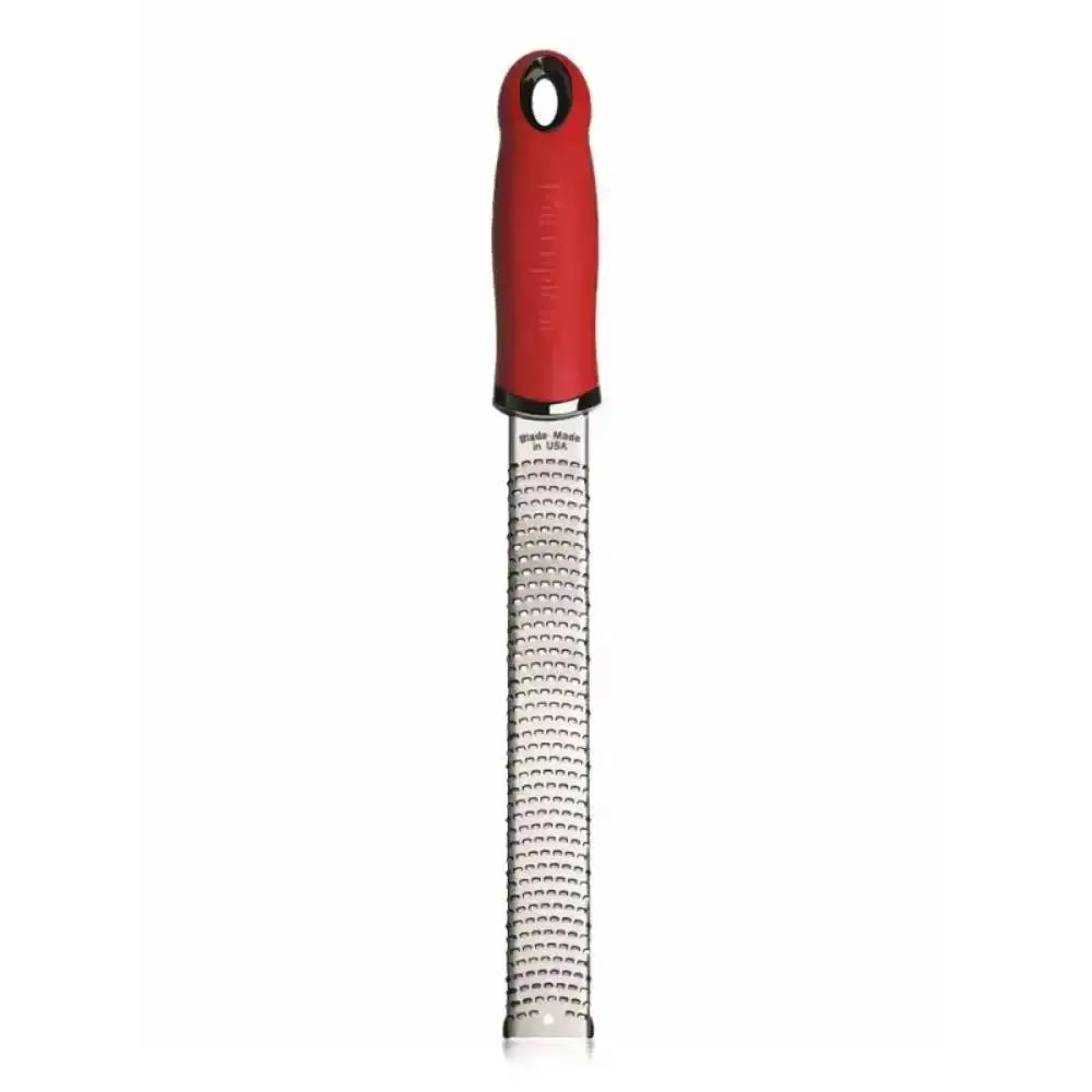 Red-handled zester on a white background