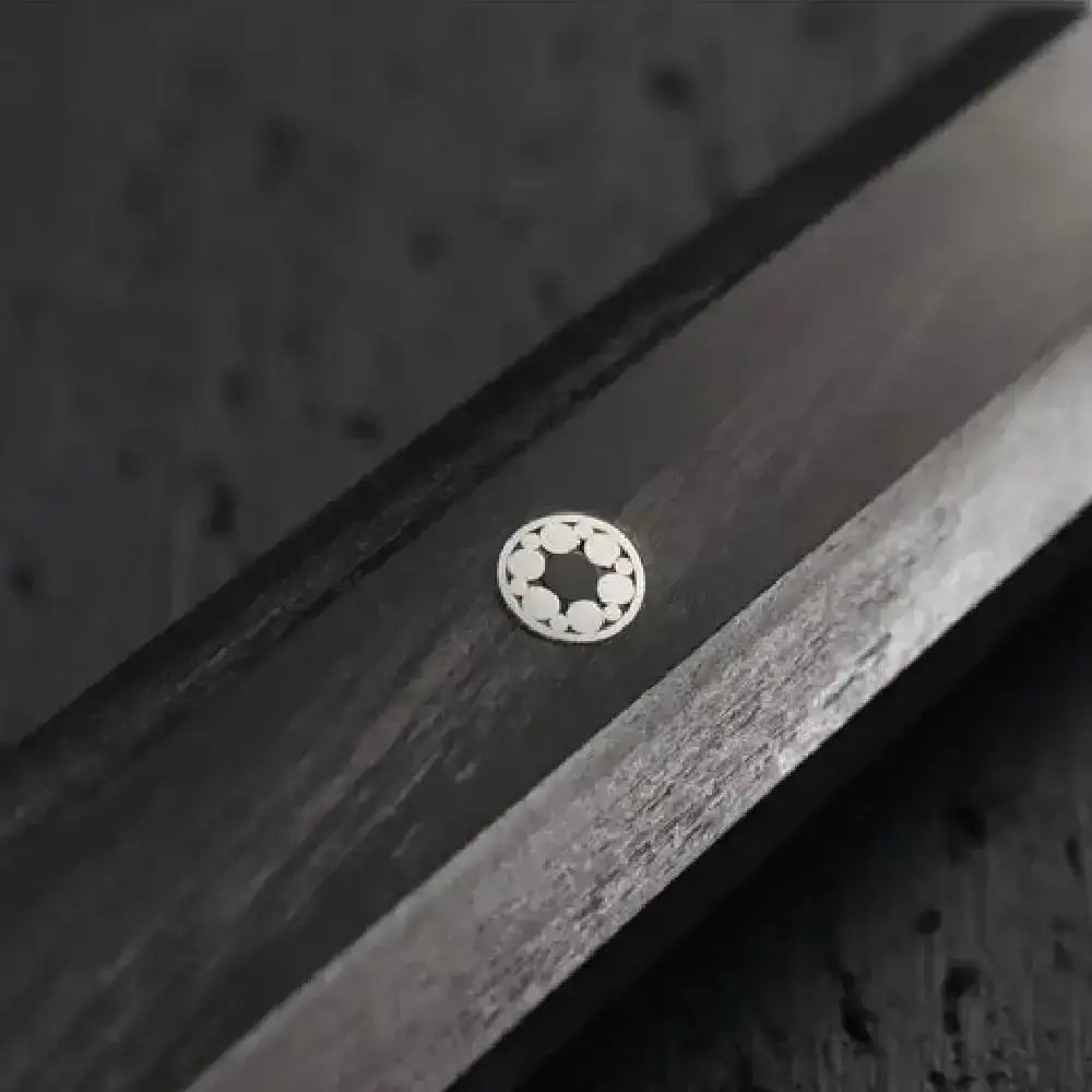 Close-up of a metallic object with a circular component on a textured background