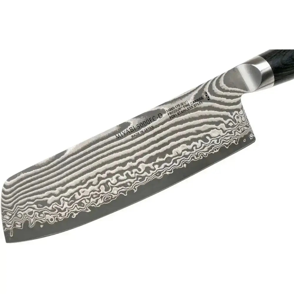 Damascus-patterned knife blade with a black handle on a white background