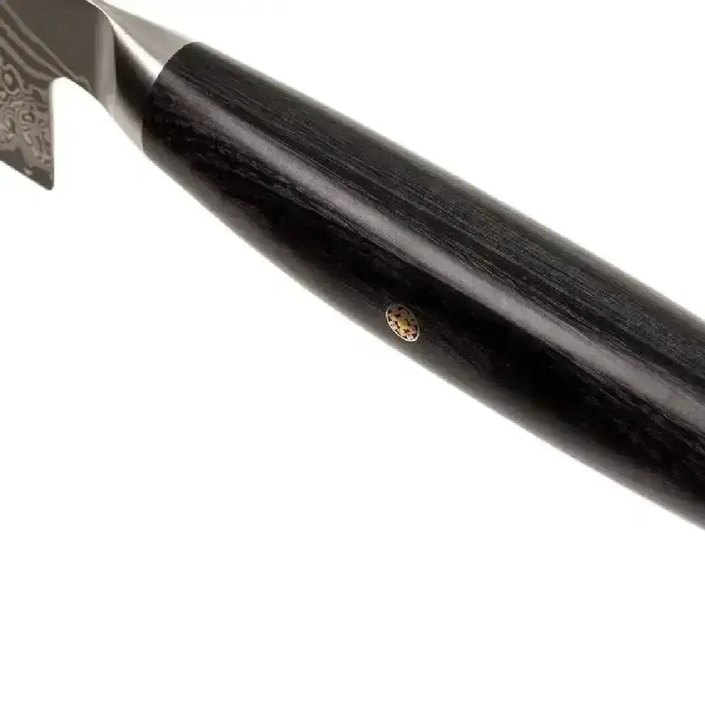 Close-up of a black-handled knife on a white background